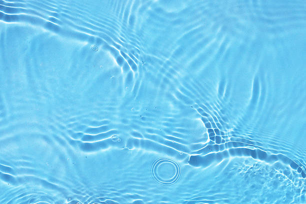 Soft ripples on the surface of clear blue water.