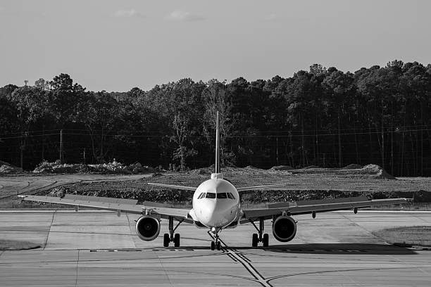 airport scene, rolling plane, landing plane, black and white photo