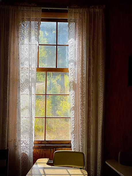 istock Old school desk near window with lace curtains 2254998369