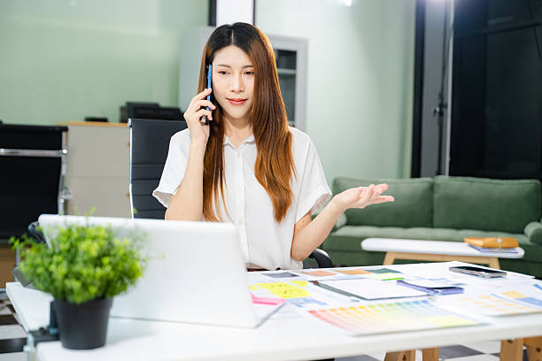 istock Creative Asian UX UI designer planning mobile app layout with sticky notes, color swatches, and wireframes. 2254998964
