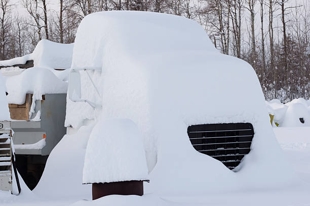 istock Old abandoned dump truck covered with high snow. 2255000424