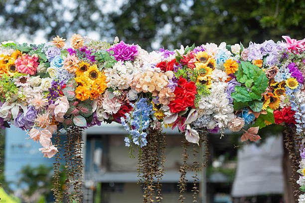 Multi-colored artificial flowers are beautifully arranged together.