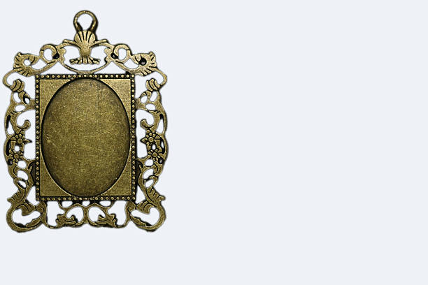Ornate Brass Pendant Frame Isolated On Pale, Single Medallion With Intricate Filigree Edges And Empty Oval