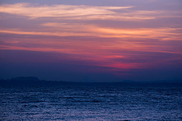 istock Sunset serenity with calm ocean waves under a radiant sky. 2255009572