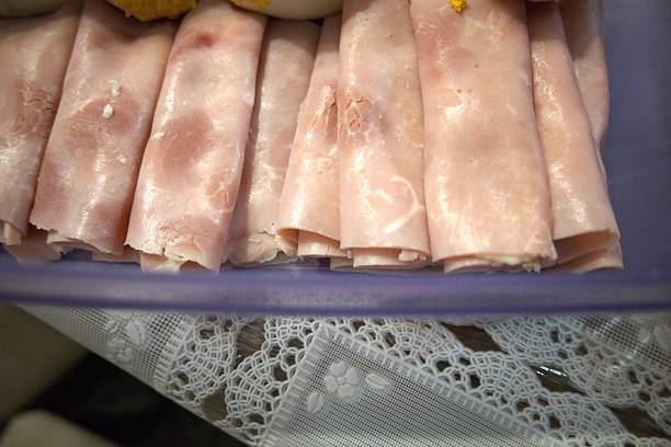 Close-up of homemade ham rolls prepared as a classic cold dish. Simple ingredients, home cooking and comfort food concepts.