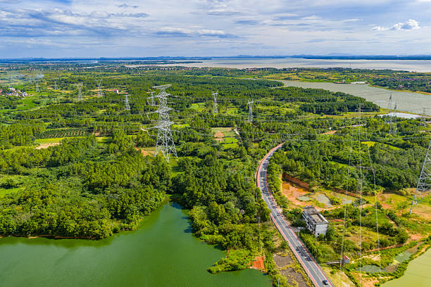 istock High-voltage transmission towers under blue sky and white clouds 2255014786