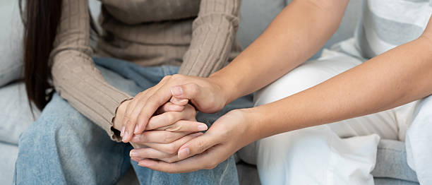 istock Couple hold hand support each while discussing family issues with psychiatrist. Husband encourages and empathy wife suffers depression. psychological, save divorce, Hand in hand together, trust, care 2255015986