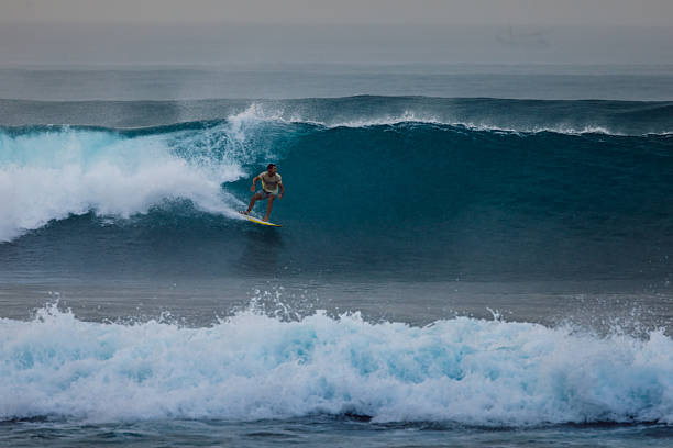 Man is surfing on Canggu beach, Bali Island.Indonesia.