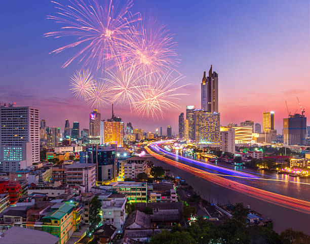 Aerial Bangkok Cityscape with New Year Fireworks and Chao Phraya River