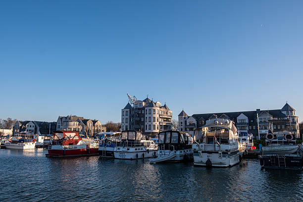 Werne, Germany – December 23, 2025: Small marina on the Lippe River in Werne, with boats on the river and buildings visible in the background.
