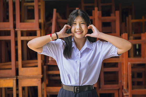 Cute Asian student teen in uniform learning enjoy happy smiling learning education in school campus