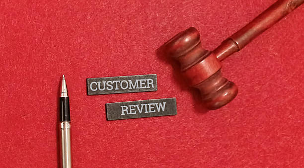 istock Customer review concept with gavel and pen on red background 2255018101