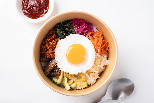 Bibimbap, Korean food, Cooked rice with vegetables, pork and egg eating with gochujang