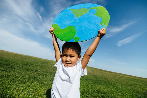 istock Boy holding globe symbolizing care for the planet 2255022709