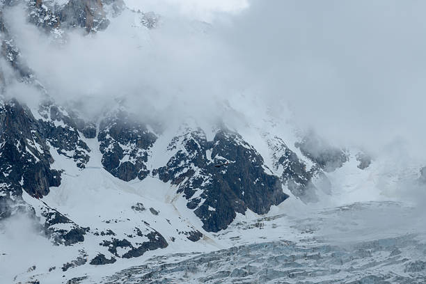 istock Misty glacier and rugged alpine cliffs in clouds 2255027100