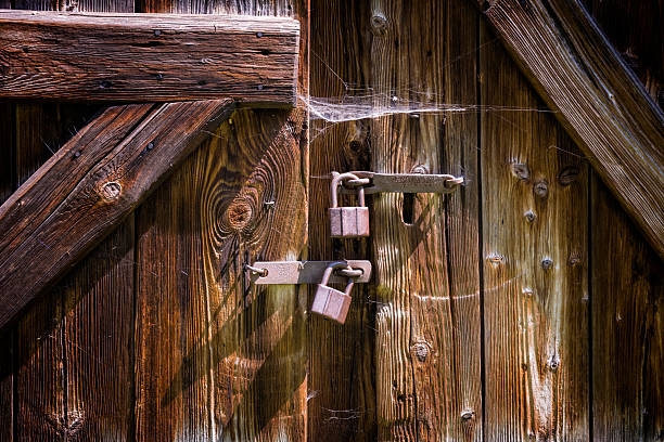 Old wooden barn shutter with iron padlocks
