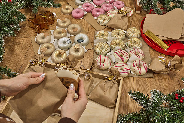 Homemade donut-shaped soap arranged for Christmas and New Year's gift wrapping, featuring festive decorations and cozy ambiance with copy space