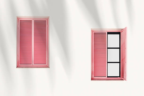 istock Retro Window with pink Shutters Jalousie on light pink background with palm leaf shadow, Closed and open Window frames wood on outdoor wall building. Minimal design abstract. Summer, travel concept 2255032134