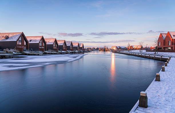 A colourful, winter sunrise in modern neighbourhood at the waterfront. Meerstad, the Netherlands.