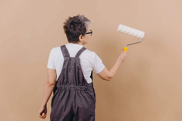 istock Woman painting wall with roller during home renovation 2255033206