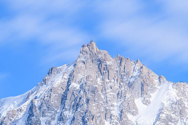 Aiguille du Midi peak in the Alps. Chamonix valley landscape of a prominent rocky towering mountain peak in French Alps. Chamonix-Montblanc area beautiful landscape of Aiguille du Midi summit, France