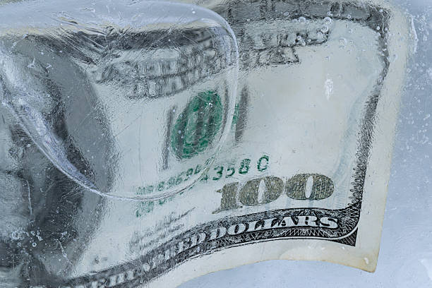 istock One Hundred Dollar Bill Frozen in Ice Block 2255035639