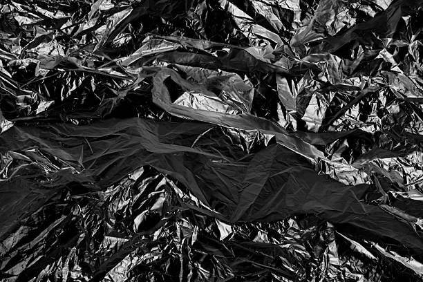 istock crumpled semi transparent plastic foil texture isolated on black 2255035941