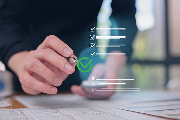 istock Businessman use pen review paper data charts and digital documents, utilizing intelligent management system to validate records and streamline final approvals workflow and quality assurance 2255036897