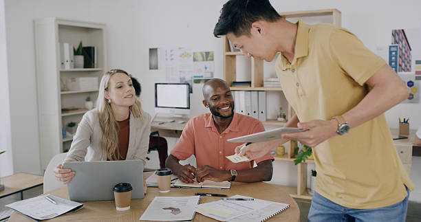istock Man, tablet and team with sticky note at office, happy and solution for project at graphic design startup. People, woman and group with planning, documents or meeting for feedback at creative agency 2255038847