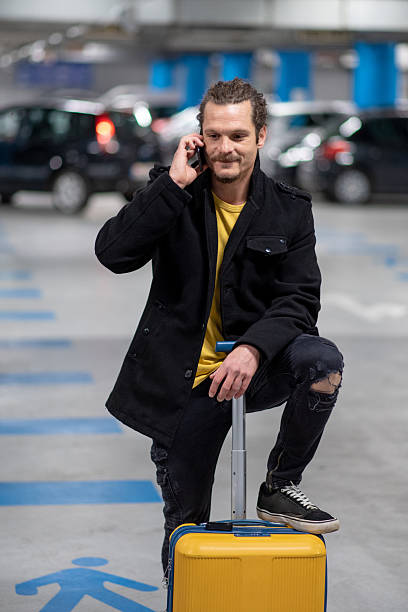 istock Man using phone in underground car parking garage 2255040012