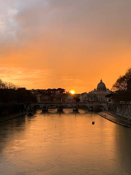 Sunset on the Umberto I bridge in Rome, with the Vatican in the background