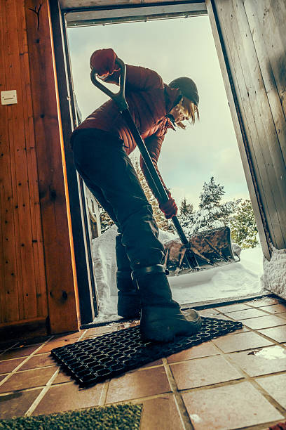 istock Senior woman clearing snow from her front door 2255045568