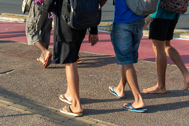 Salvador, Bahia, Brazil - January 3, 2026: People are seen walking along the Barra boardwalk in Salvador, Bahia, showcasing a blend of beach and urban lifestyle.