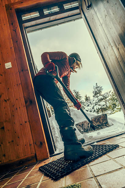 istock Senior woman clearing snow from her front door 2255045694