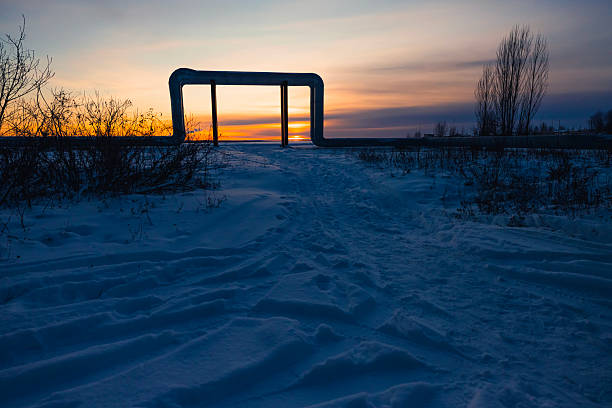 Snow covered benches of the old stadium. Stadium stands after heavy snowfall in winter. Traces of people, toned image.