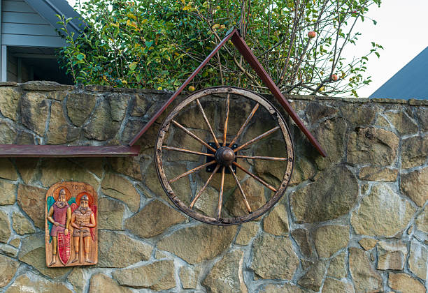 An old wooden wagon wheel was placed on the ground.