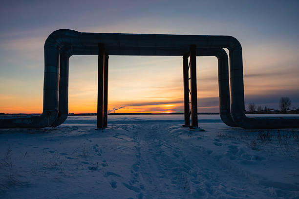 Pipes. Sunset on field. Winter landscape