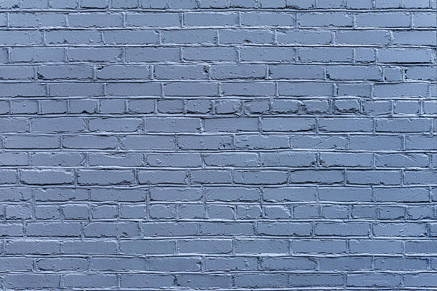 istock Blue Painted Brick Wall. Brick wall texture with visible masonry lines and uneven paint coverage. Urban brick texture used as background, backdrop, mockup for urban design 2255049293