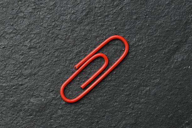 Leadership concept. Colorful paperclips on the white background