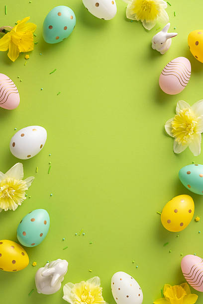 istock Colorful vertical Easter scene featuring pastel eggs, a white bunny, and yellow flowers arranged around a vibrant lime backdrop. Perfect for festive greeting cards, spring promotion, and seasonal stock imagery 2255071721