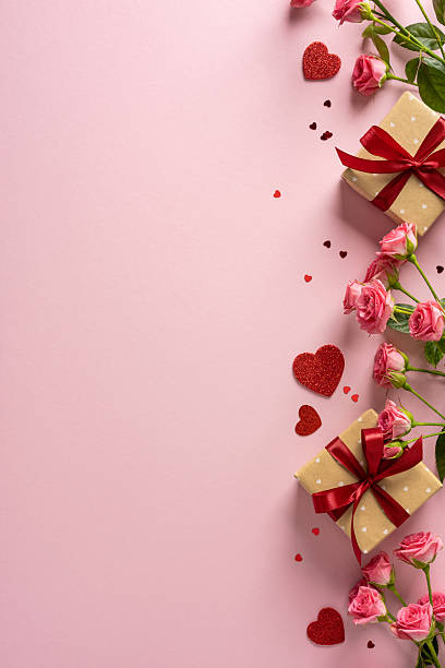 Romantic vertical scene with pink background, roses, wrapped gifts, red ribbons, and scattered hearts conveying love, warmth, and Valentine mood for celebration and gifting
