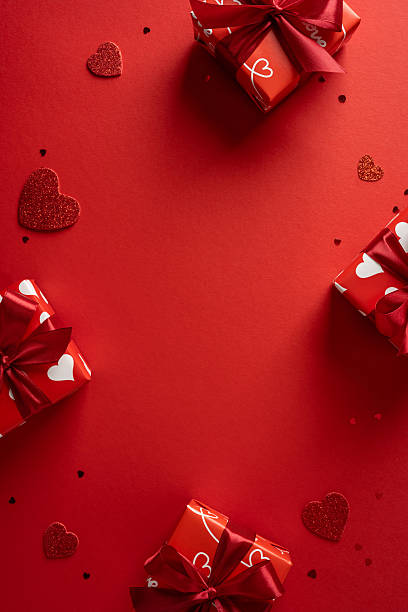 istock Romantic vertical Valentine setup featuring gift box, red ribbon, and heart accents on a bold red backdrop to evoke love, celebration and affectionate moments suitable for greeting cards and promotion 2255071804