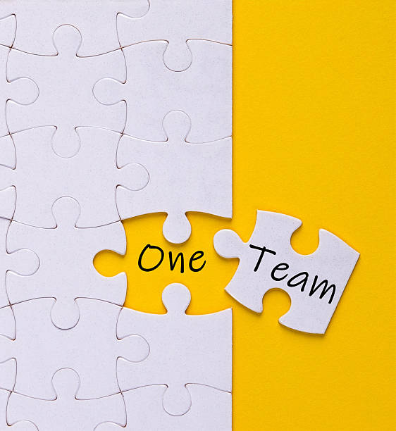 Puzzle piece uniting to form one team concept