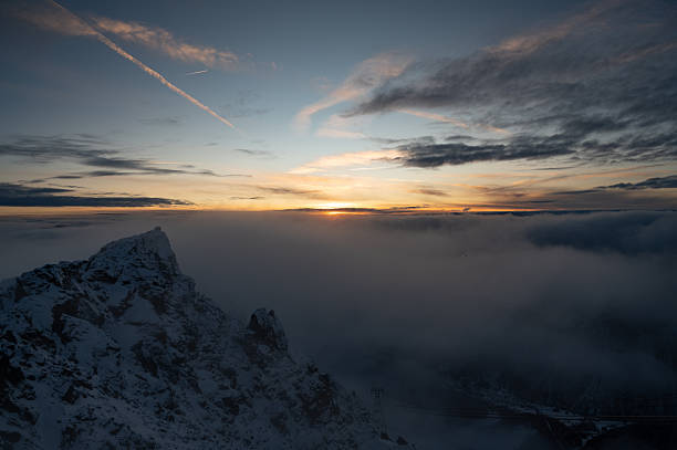 Winter scenery above the Alps. Pejo Mountain at 3000 mt, in Trentino, Italy, at dawn. Snow clad mountains and dramatic cloudscape