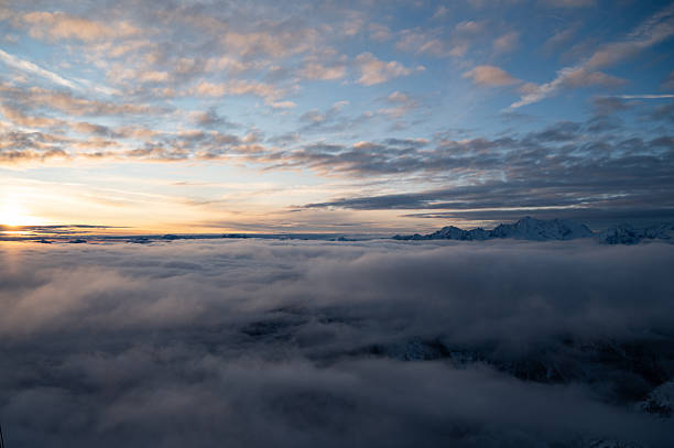 Winter scenery above the Alps. Pejo Mountain at 3000 mt, in Trentino, Italy, at dawn. Snow clad mountains and dramatic cloudscape