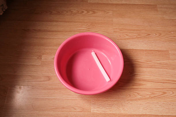 Pink plastic basin with white candle