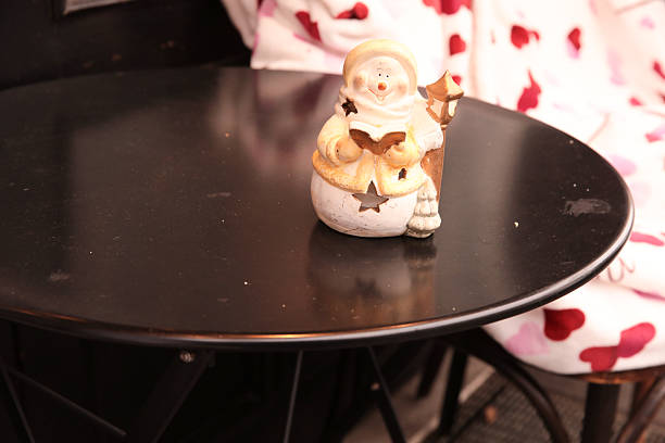 Ceramic snowman figurine on round table