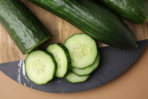 istock Fresh cucumbers on beige background, top view 2255076528