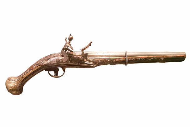 Closeup of antique flintlock gun showing the hammer ,flint , pan and frizzen in black and white.