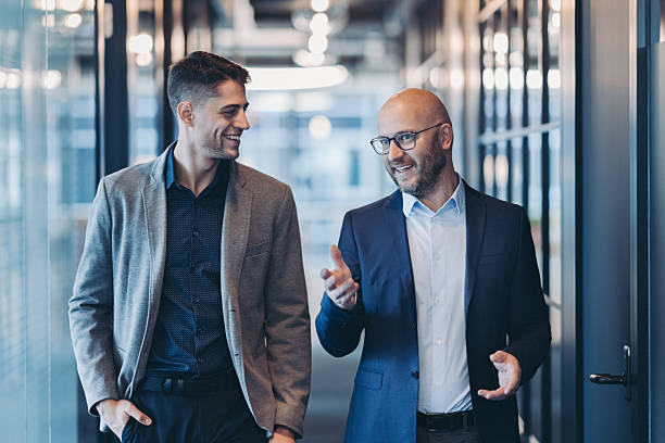 istock Businessmen having a conversation in the corridor 2255085558